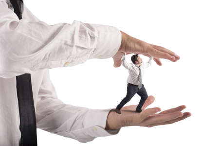 Big hands that crush a small manの写真素材