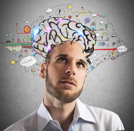 Businessman with thoughtful expression with brains designedの写真素材