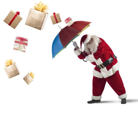 Santaclaus is protected by gifts with umbrellaの写真素材