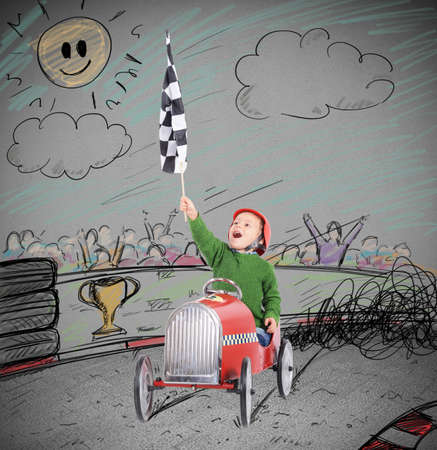 Child riding a toy car with flagの写真素材