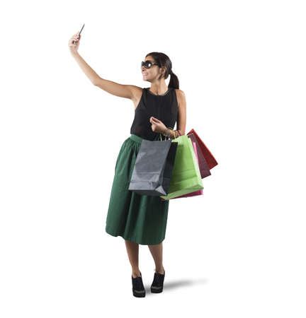 Girl gets a selfie with her purchasesの写真素材