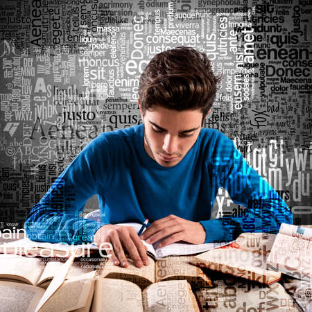 Teenager boy focused while studying many booksの写真素材