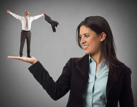 Woman holds on hand an exultant man