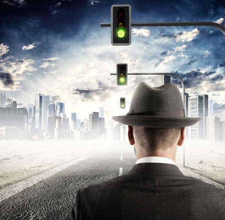 Man walking on street with traffic lightsの写真素材