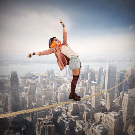 Clown on a rope above the cityの写真素材
