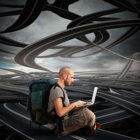 Explorer with computer on winding roads backgroundの写真素材