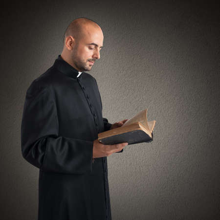 Man priest reads the bible sacred textの写真素材