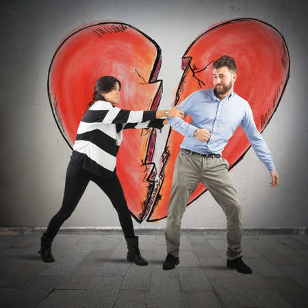 Couple arguing on background a broken heartの写真素材