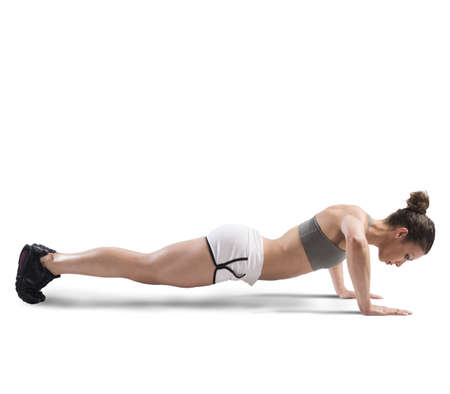 Athletic girl is training doing push up