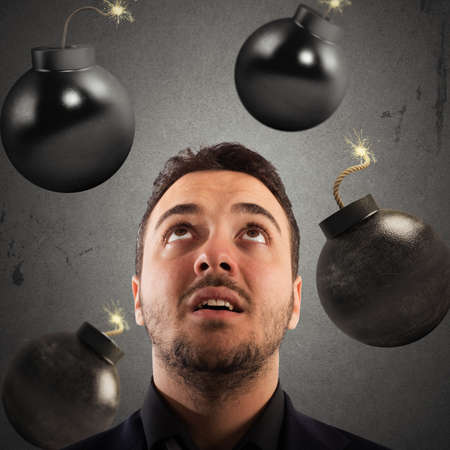 Man with worried expression with bombs falling