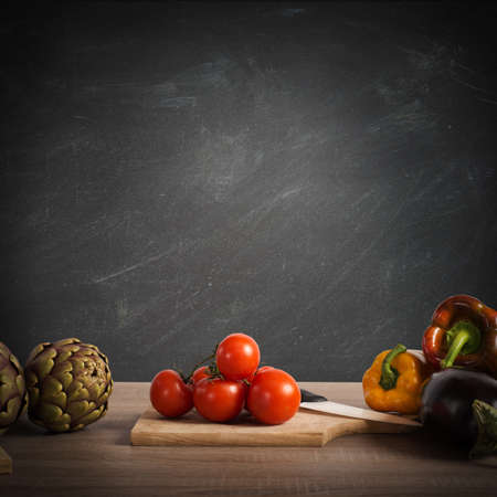 Vegetables on a table with blackboard backgroundの写真素材