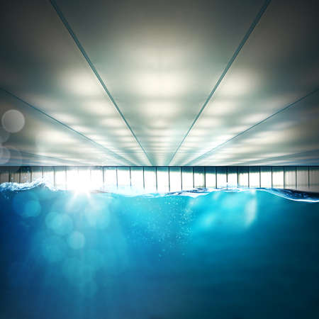 Indoor swimming pool with rays of lightの写真素材