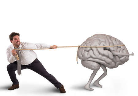 Man pulls the rope with brain drainの写真素材