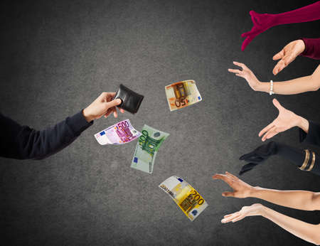 Hand of a man with wallet and banknotesの写真素材