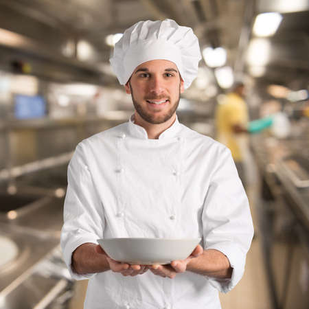 Chef with happy expression holding his plateの写真素材