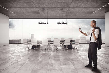 Businessman with cell in a meeting roomの写真素材