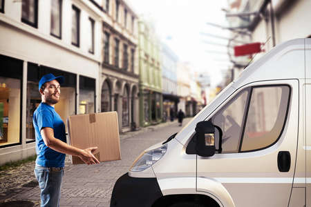 Man with box next to a truckの写真素材