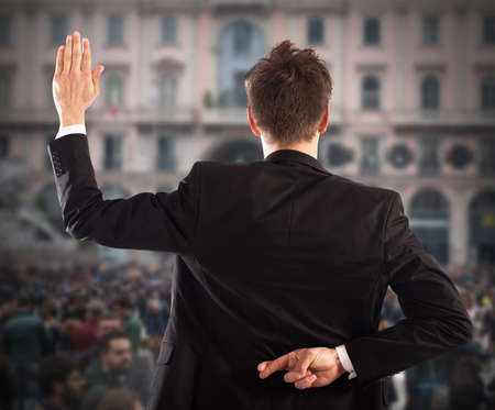 Man makes gesture with hand behind back