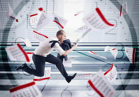 Man runs screaming with calendar sheets backgroundの写真素材