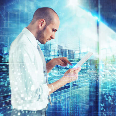 Businessman touching tablet screen on abstract backgroundの写真素材