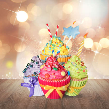 Colored sweet cupcake with decorations and candlesの写真素材