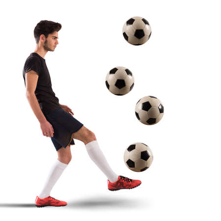Teenage soccer player dribbling with four soccerballの写真素材