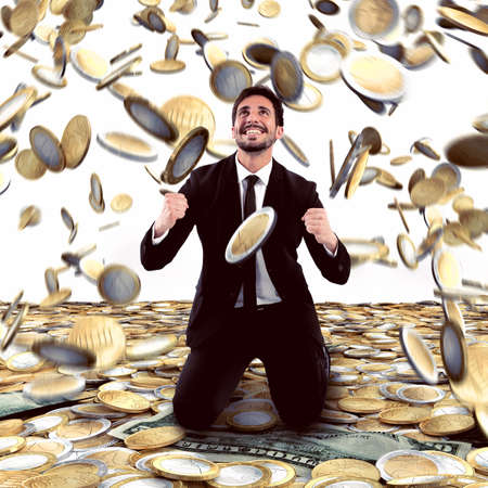 Businessman exults under a rain of moneyの写真素材
