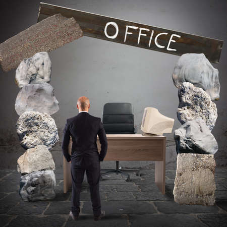 Man looks at an office with rocksの写真素材