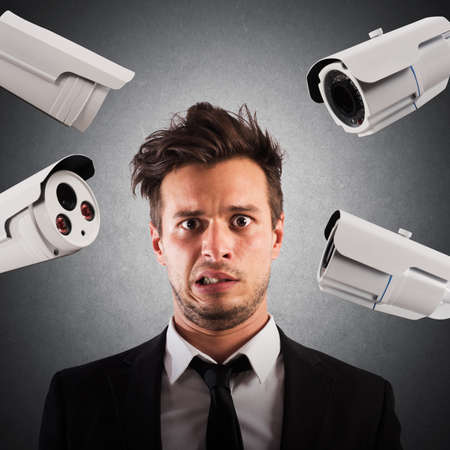 Anxious man with cameras pointed at him