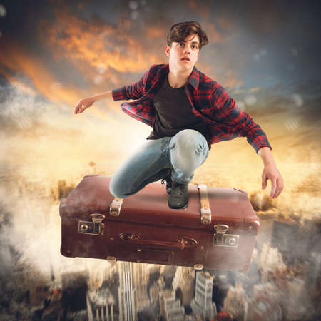 Boy flies on suitcase over the city