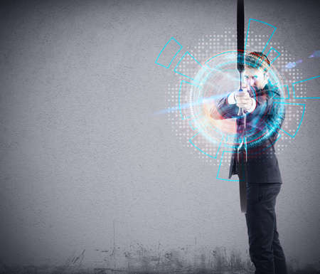 Confident businessman with bow pointing a target