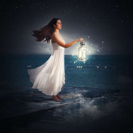 Woman walks at night with a lantern