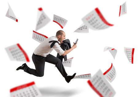 Man runs screaming with calendar sheets backgroundの写真素材