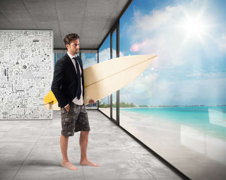 Businessman with suit and swimsuit at officeの写真素材