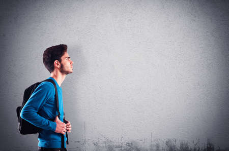 Teenager student with backpack with wall backgroundの写真素材