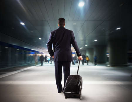 Businessman walking in the airport with suitcaseの写真素材