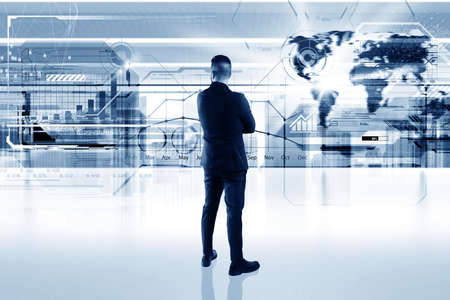 Business man in office looks futuristic interfaceの写真素材