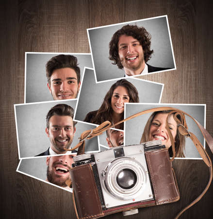 Vintage camera with leather belt on wooden background