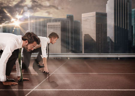 Business men competing in a race trackの写真素材