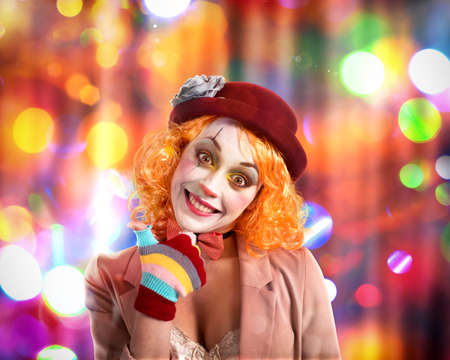 Smiling clown with hat and background with colored lightsの写真素材