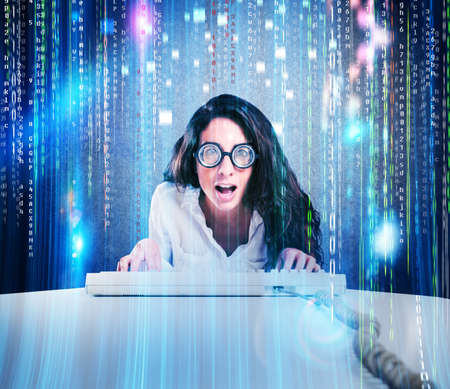 Woman with astonished expression and eyeglasses with computer keyboardの写真素材