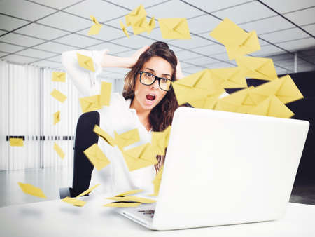 Desperate woman in office for too many e-mailの写真素材