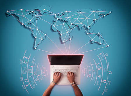 Man writes at computer with world map