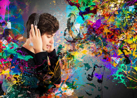 Teen boy listens to music with headphonesの写真素材