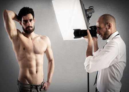 Photographer takes pictures of a man modelの写真素材