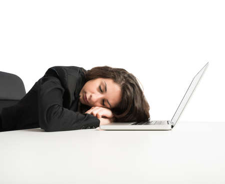 Woman exhausted from overwork sleeping over computerの写真素材