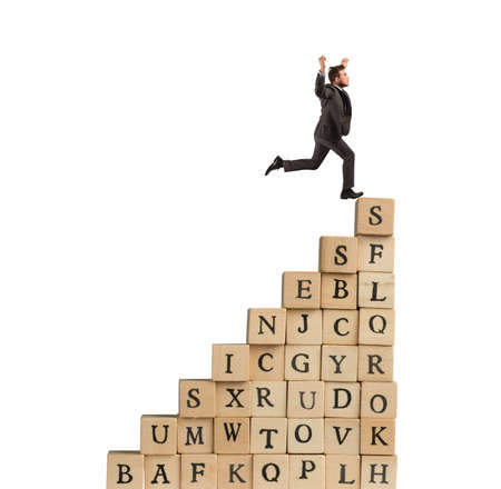 Businessman climb a staircase cubes wooden lettersの写真素材