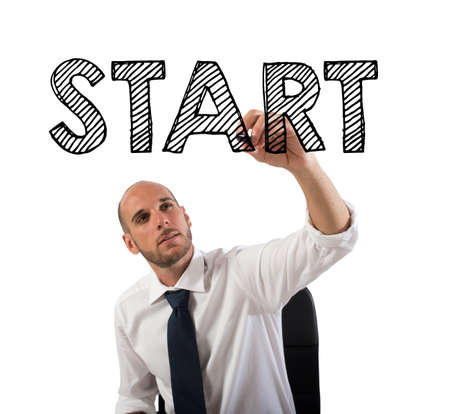 Businessman writing the word start with a penの写真素材