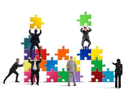 Team of businesspeople build a puzzle constructionの写真素材