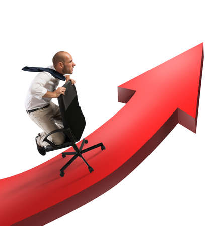 Determined businessman over a big red arrowの写真素材